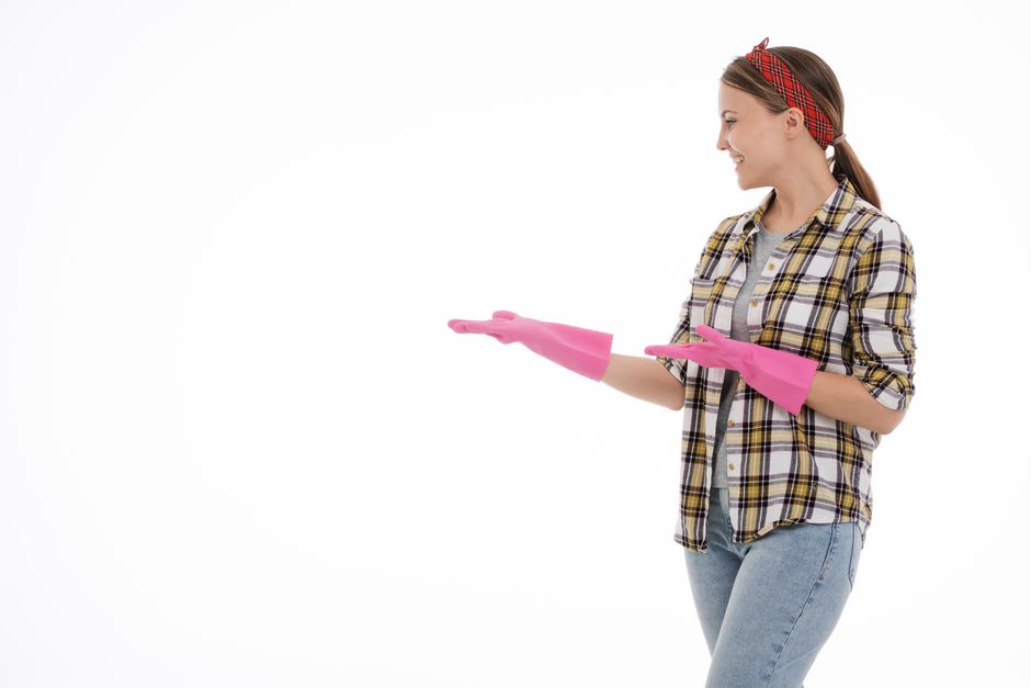 Happy professional cleaner smiling in a neat home