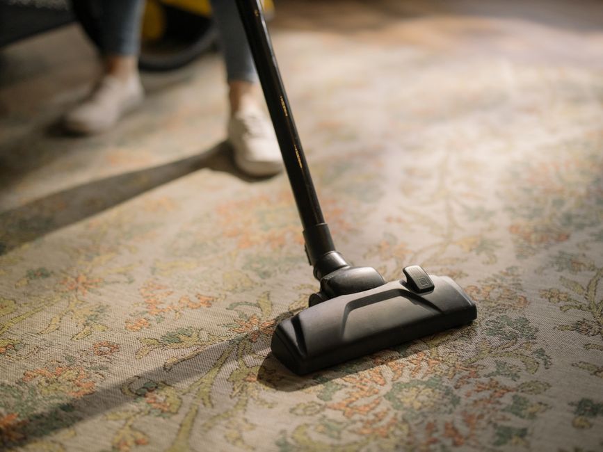 Detailed vacuuming of living room carpet